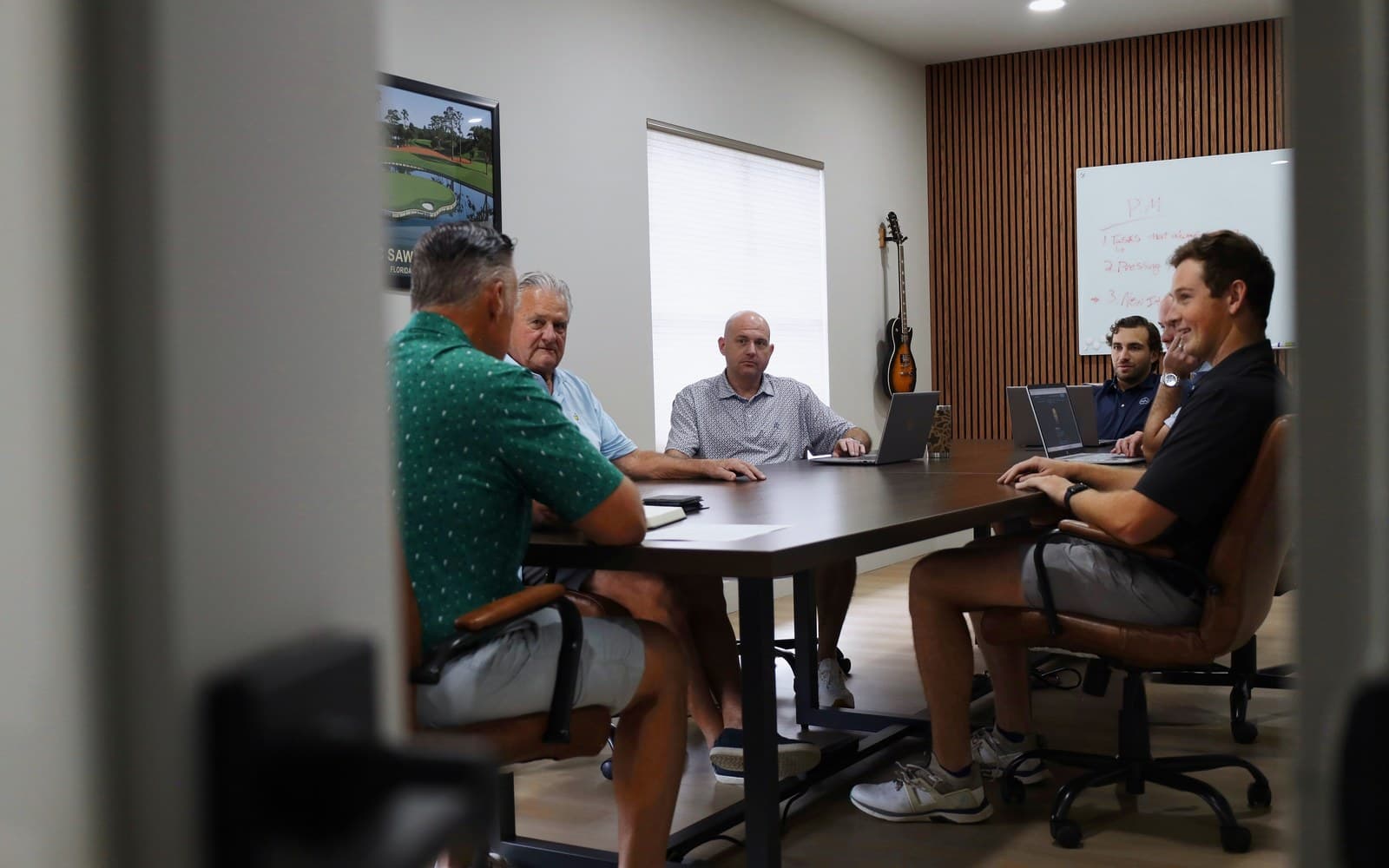 The H2 Advisors team around the conference table at the Jacksonville office
