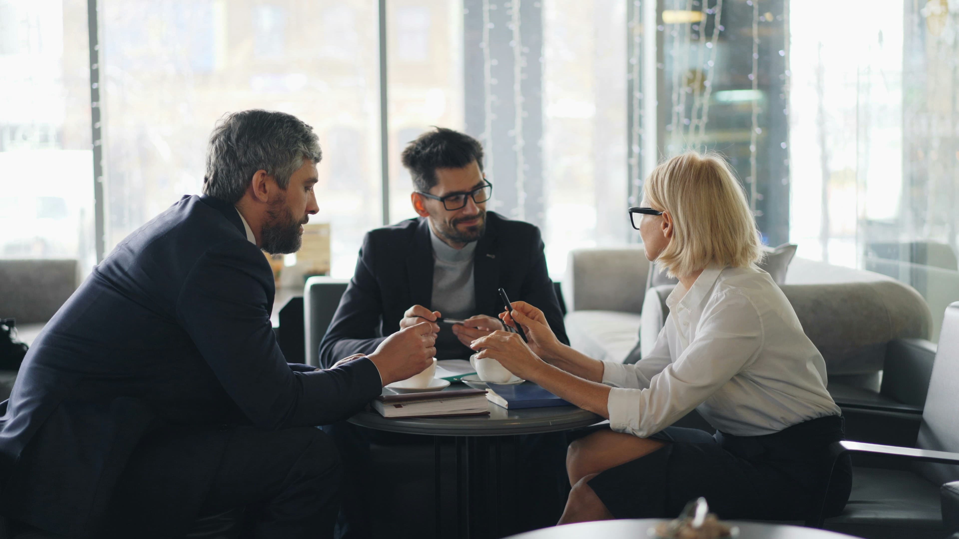 A team meeting over coffee to talk through a client's goals